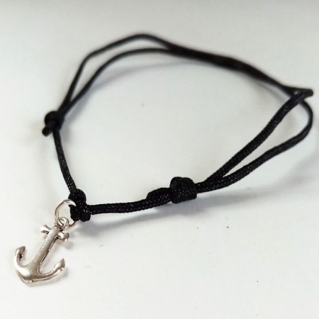 Silver anchor charm on black anklet