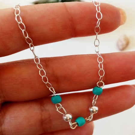 Turquoise bead detail on silver anklet